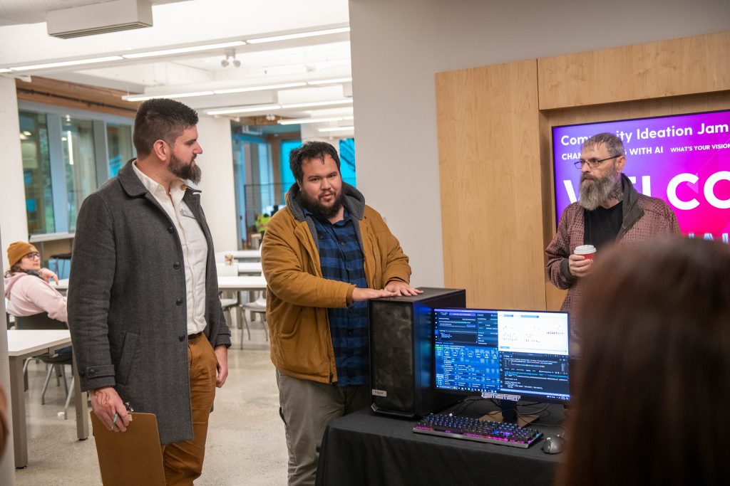 Derek Froese looks over the work of one of the Ideation Jam projects