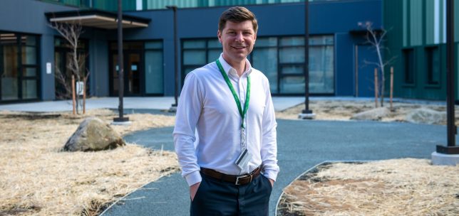 Nathan Speedie stands in front of UFV's student housing building.