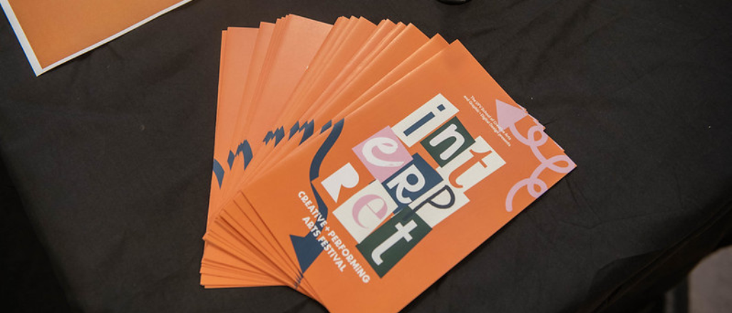 image of interpret festival brochures fanned across a table